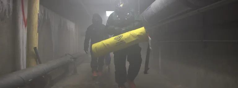 SD Natioanl Guard Training with SURF in a foggy tunnel workiing in hasmat suits.