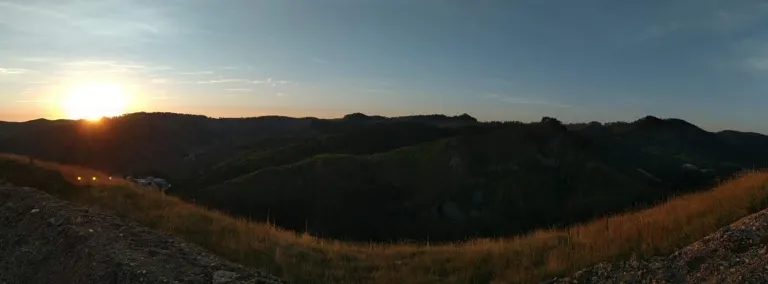 An impage showing the sun coming up over the hills near SURF.