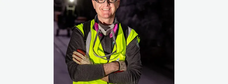 Mike Headley at the 4850L in full PPE including a reflective vest, gloves, safety glasses, a hard hat, and a resperator around his neck. 