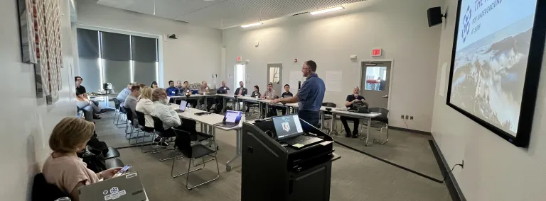 Mike Headley speaking to a group of peopple gathered at the Sanford Lab Homestake Visitor Center classroom for the GPN Quantum Research Collaboration Workshop in July of 2024