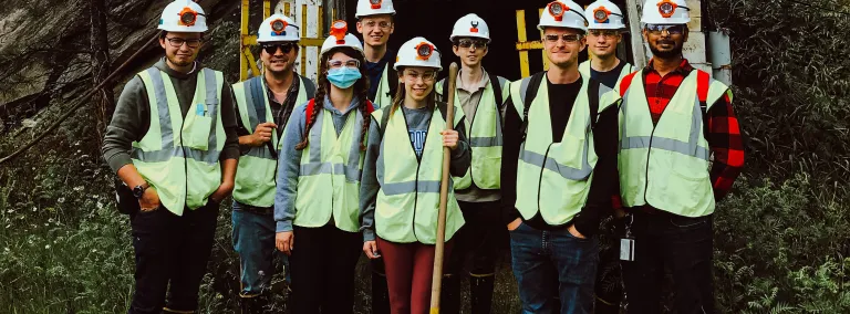 a group of students in safety gear stand at the enterance to the 300 Level