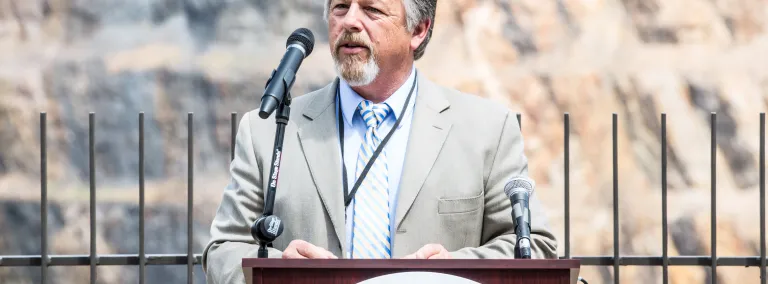 Casey Peterson speaks in front of the Open Cut in Lead, South Dakota 