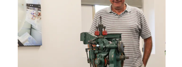 Mike Johnson stands behind a lily controller in a conference room 