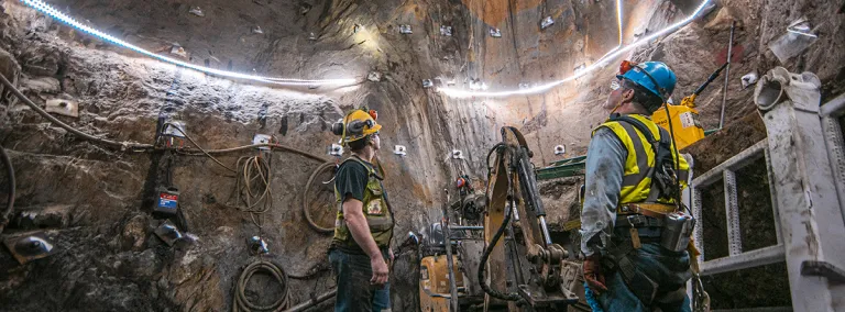 two people stand at the base of the ore pass