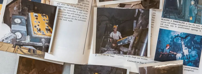 old photos spread out on a desk