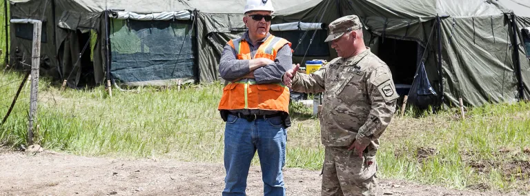 National Guard and Sanford Lab works on road.