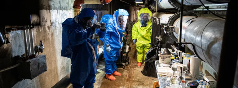 Sgt. Travis Johnson, left, and Sgt. Domonic Delaney, both of the 81st Civil Support Team, assisted by the Rapid City Fire Department Hazardous Materials (HAZMAT) team, take samples of biological agents during a chemical and biological weapons response exercise at the Sanford Underground Research Facility (SURF) in Lead, South Dakota, April 26, 2022. 