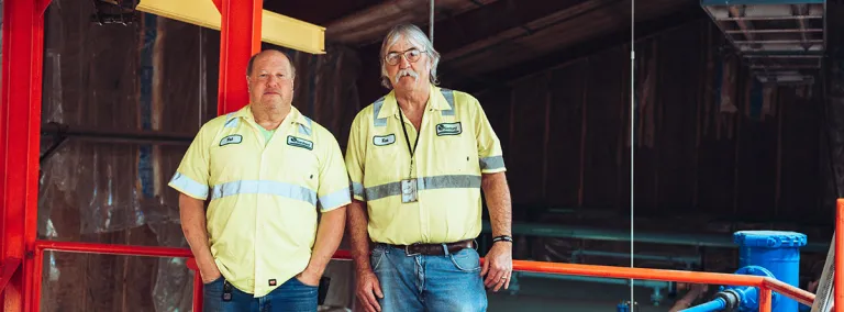 Pat Hasson and Ken Noren stand in the WWTP