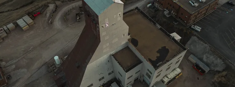 An illuminated pink ribbon on the Yates Headframe