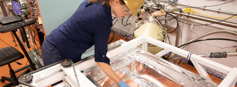 Researcher leans over a low background counter