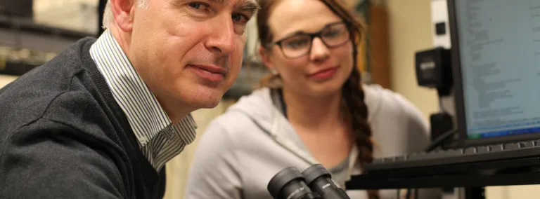 Steve Smith, professor and director of Nanoscience and Nanoengineering at the SD Mines, works with student.