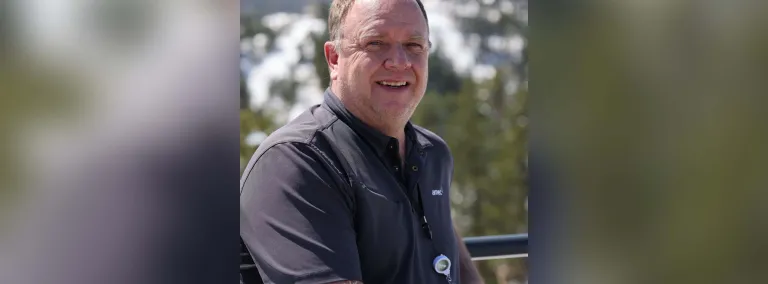 Photo of smiling person in front of Kirk Canyon