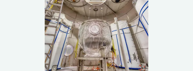 Inside the LZ water tank, assembly has begun on the Outer Cryostat Vessel.