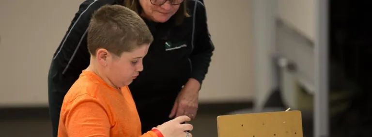 Dr, Peggy Norris works with a student.