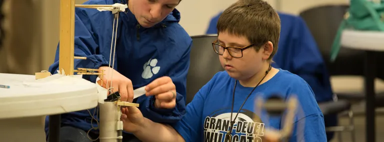 Two students work on the hoist challenge.