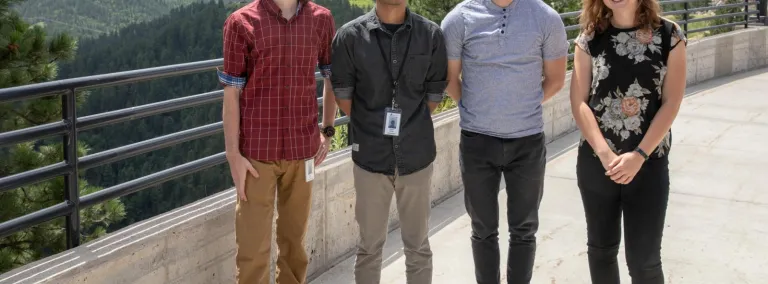 Four students stand outside 