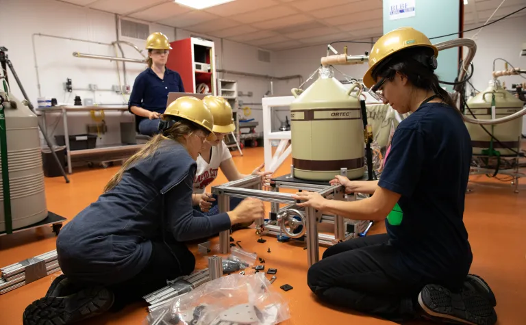 Students put the finishing touches on a detector in the BHUC.