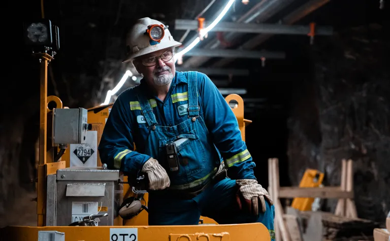 Charlie Roth leans on the motorcar underground 