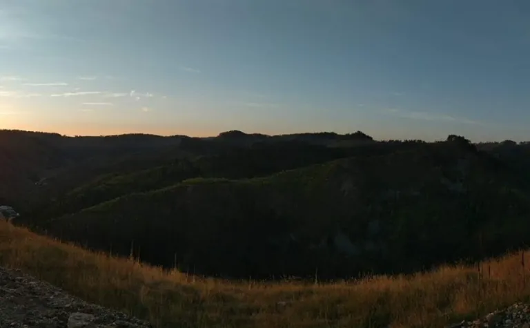 An impage showing the sun coming up over the hills near SURF.