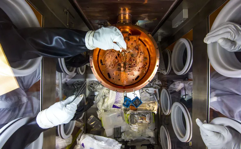 Reseachers work on the MAJORANA experiemnt at SURF inside a clean box with gloves.