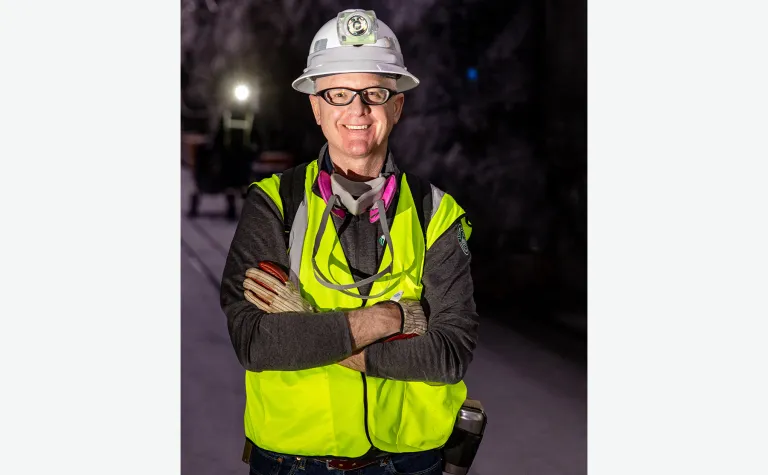 Mike Headley at the 4850L in full PPE including a reflective vest, gloves, safety glasses, a hard hat, and a resperator around his neck. 