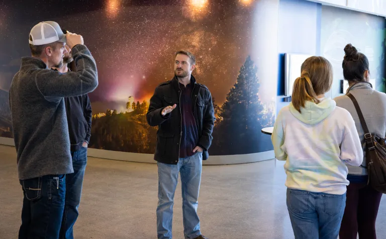 scientist talks to tourists