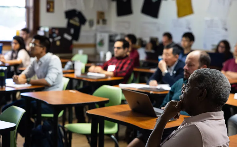 Attendees listen in a classroom setting to one of many presentations during the 2023 CETUP* summer workshop at SURF. 