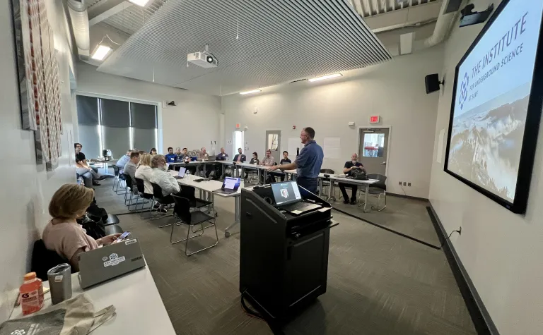 Mike Headley speaking to a group of peopple gathered at the Sanford Lab Homestake Visitor Center classroom for the GPN Quantum Research Collaboration Workshop in July of 2024