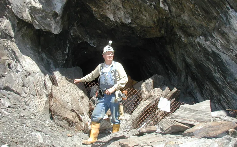 Tom Regan stands in front of a Mine opening