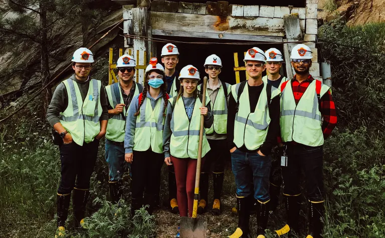 a group of students in safety gear stand at the enterance to the 300 Level