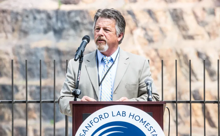 Casey Peterson speaks in front of the Open Cut in Lead, South Dakota 