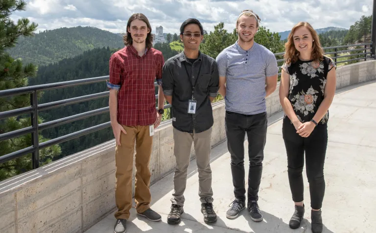 2018 Sanford Lab summer interns stand in front of Grizzly Gulch after their presentations. 