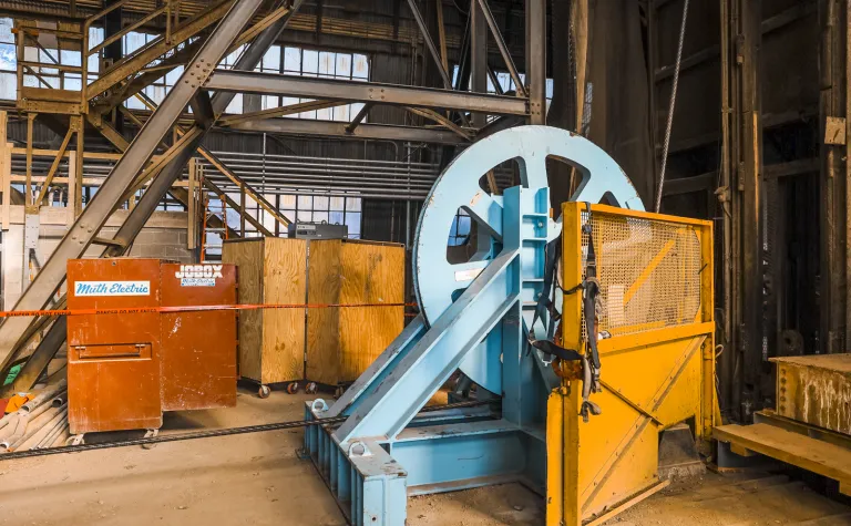 A wheel spins as thick steel cables are replaces in the Ross Shaft. 