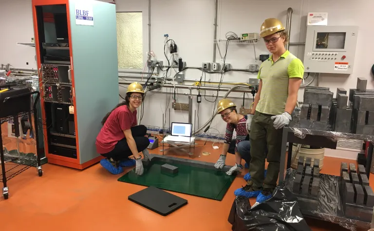 Three students build a low-background counter.