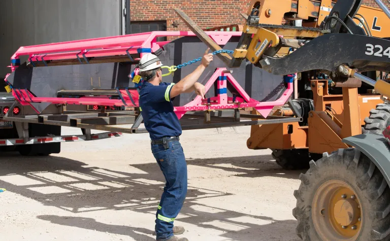 A prototype container is offloaded from a truck.