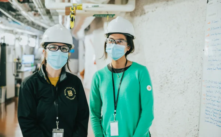 Gina Gibson (left), SURF AiR program coordinator, and Leekyung Kang (left), 2021 SURF AiR, during a tour of the 4850 Level. 