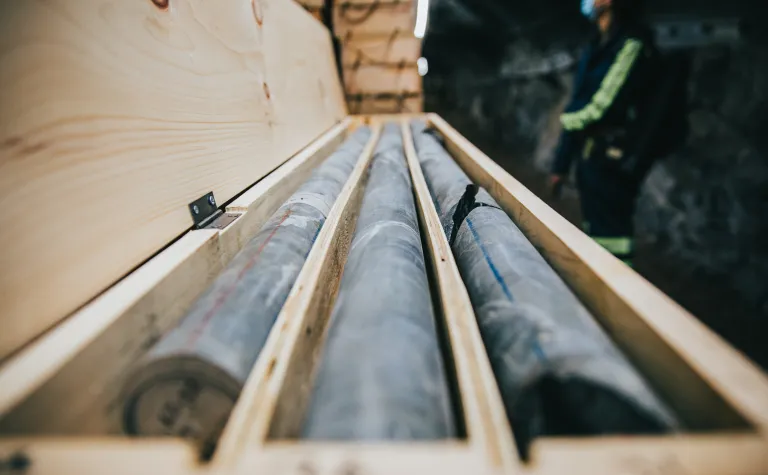 three cylinders of rock core in a box