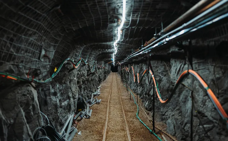 an underground drift at SURF is lit by a single string of lights on the back of the drift