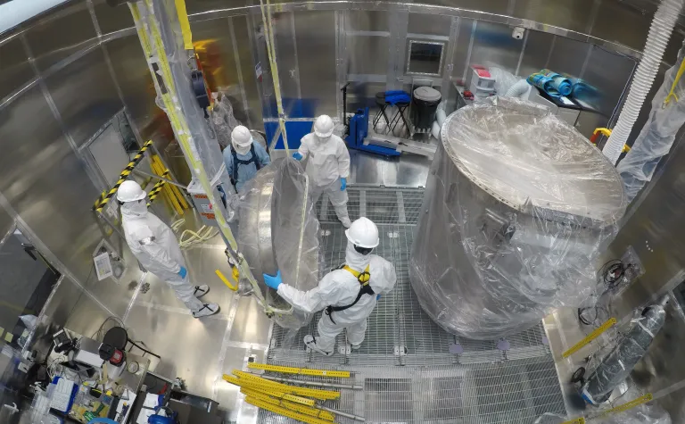 Engineers clean the LUX-ZEPLIN cryostat inside the Surface Lab's Class 1000 clean room in preparation for the next generation search for dark matter. 