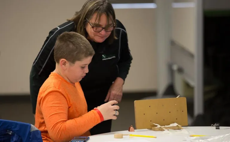 Dr, Peggy Norris works with a student.