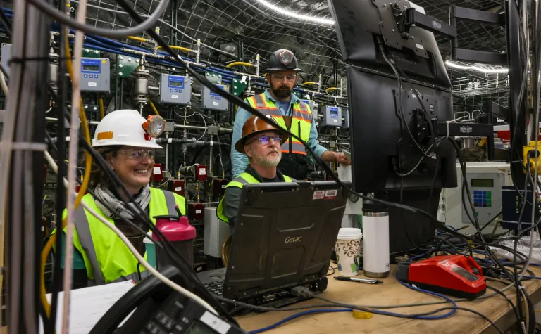 Dr. Hunter Knox, an Earth scientist at PNNL (left),  works with Vince Vermeul,  an environmental engineer at PNNL (seated), and Dr. Jeff Burghardt, an Earth scientist at PNNL, at 4100 feet below the surface on the EGS Collab experiment, which set the stage for CUUSP at SURF.  