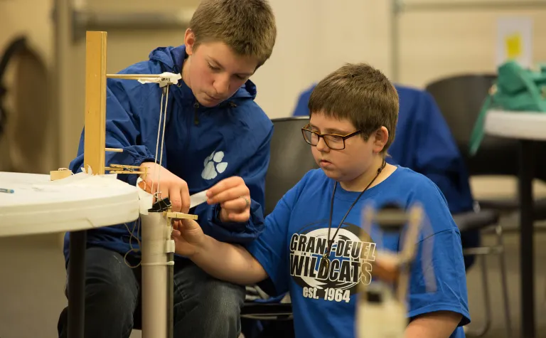 Two students work on the hoist challenge.