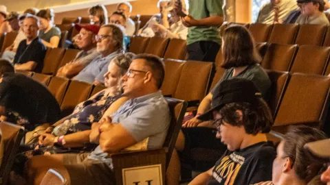 A young person asks questions during a panel discussion at Neutrino Day 2024.