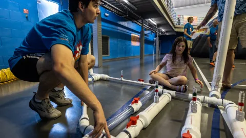 A volunteer runs a demonstration of underground air flow at Neutrino Day 2024.  