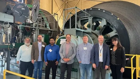 A group with the 2024 GPN Quantum Research Collaboration Workshop tours a hoistroom at SURF